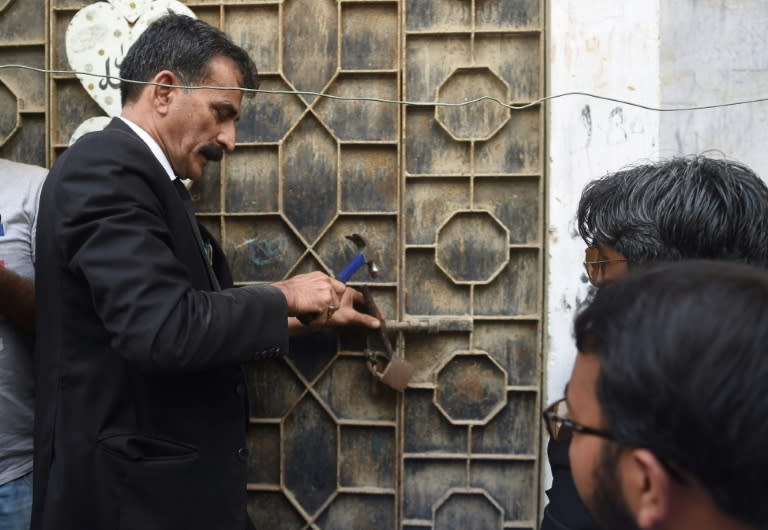 Nawab's lawyer Javed Chatari breaks the lock at her home in Karachi, nearly 20 years after her wrongful arrest