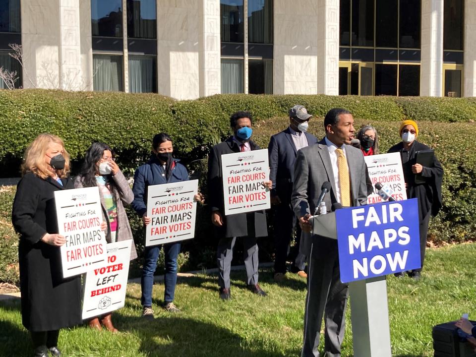 FILE - Reggie Weaver, at podium, speaks outside the Legislative Building in Raleigh, N.C., Feb. 15, 2022, about a partisan gerrymandering ruling by the North Carolina Supreme Court. The Supreme Court has ruled that North Carolina’s top court did not overstep its bounds in striking down a congressional districting plan as excessively partisan under state law. The justices on Tuesday rejected the broadest view of a case that could have transformed elections for Congress and president by leaving state legislatures virtually unchecked by their state courts when dealing with federal elections. (AP Photo/Gary D. Robertson, File)