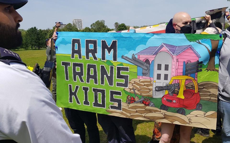 Trans rights demonstrators prominently displayed a sign proclaiming ‘arm trans kids’ 