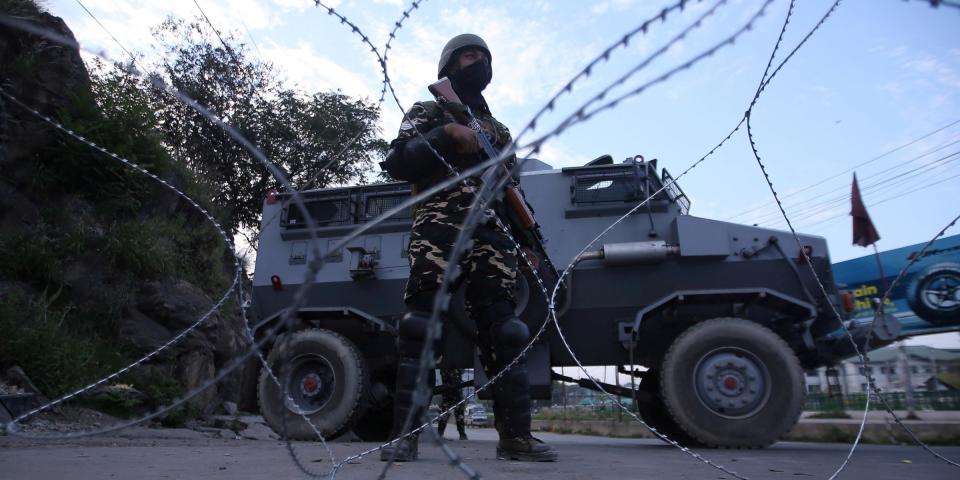 FILE PHOTO: An Indian security personnel stands guard on a deserted road during restrictions after scrapping of the special constitutional status for Kashmir by the Indian government, in Srinagar, August 23, 2019. REUTERS/Danish Ismail/File Photo