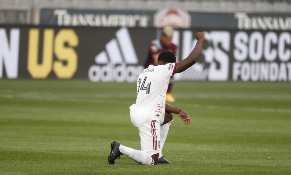 Nedum Onuoha takes a knee before the MLS game against the Colorado Rapids.