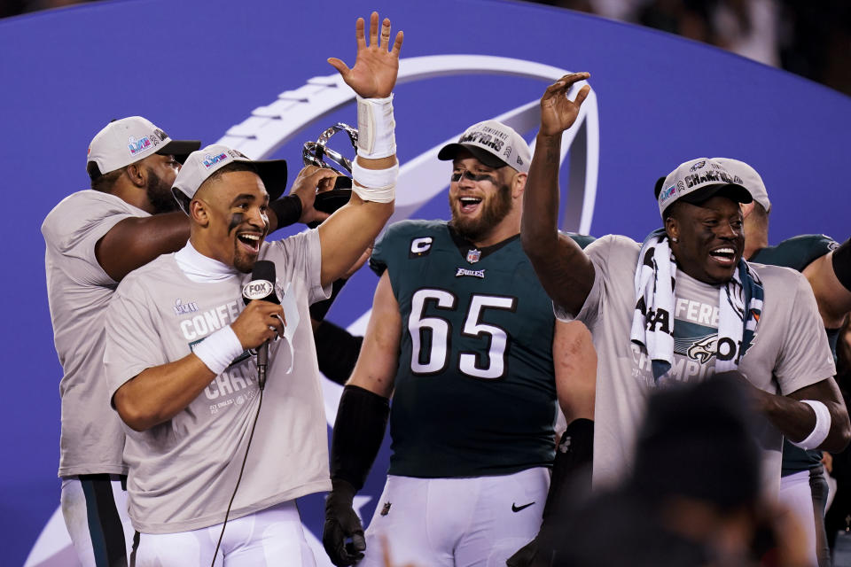 Philadelphia Eagles quarterback Jalen Hurts, left, offensive tackle Lane Johnson (65) and teammates react after the NFC Championship NFL football game between the Philadelphia Eagles and the San Francisco 49ers on Sunday, Jan. 29, 2023, in Philadelphia. The Eagles won 31-7. (AP Photo/Seth Wenig)