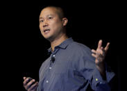 FILE - In this Sept. 30, 2013, file photo, Tony Hsieh speaks during a Grand Rapids Economic Club luncheon in Grand Rapids, Mich. Hsieh, retired CEO of Las Vegas-based online shoe retailer Zappos.com, has died. Hsieh was with family when he died Friday, Nov. 27, 2020, according to a statement from DTP Companies, which he founded. Downtown Partnership spokesperson Megan Fazio says Hsieh passed away in Connecticut, KLAS-TV reported. Hsieh recently retired from Zappos after 20 years leading the company. He worked to revitalize the Las Vegas area. (Cory Morse/The Grand Rapids Press via AP, File)