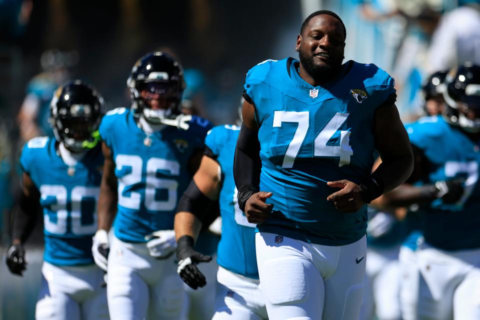 Jacksonville Jaguars offensive tackle Cam Robinson (74) runs onto the field before an NFL football matchup Sunday, Oct. 15, 2023 at EverBank Stadium in Jacksonville, Fla. The Jacksonville Jaguars defeated the Indianapolis Colts 37-20. [Corey Perrine/Florida Times-Union]