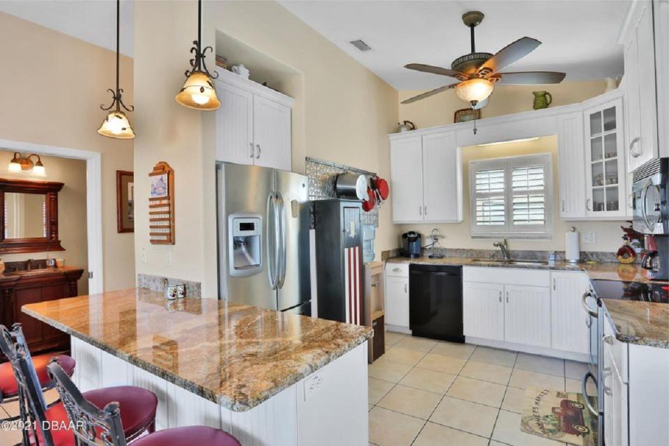 The top floor holds this beautiful kitchen with granite countertops, stainless-steel appliances and a breakfast bar.