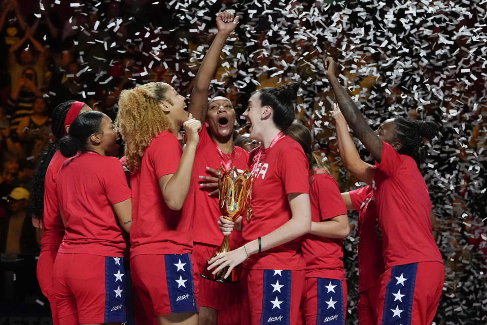 Gold medalists the United States hold their trophy as they celebrate on the podium after defeating China in the final at the women's Basketball World Cup in Sydney, Australia, Saturday, Oct. 1, 2022. (AP Photo/Mark Baker)