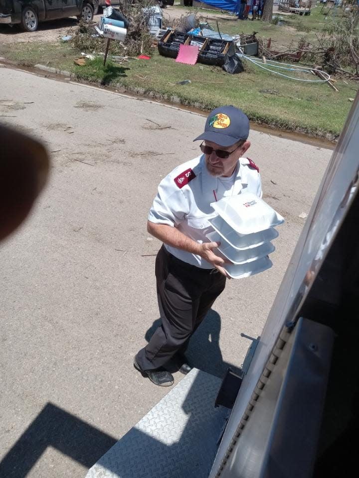 Major Joe Burton of the Salvation Army carries supplies to help those affected by the Perryton tornado.