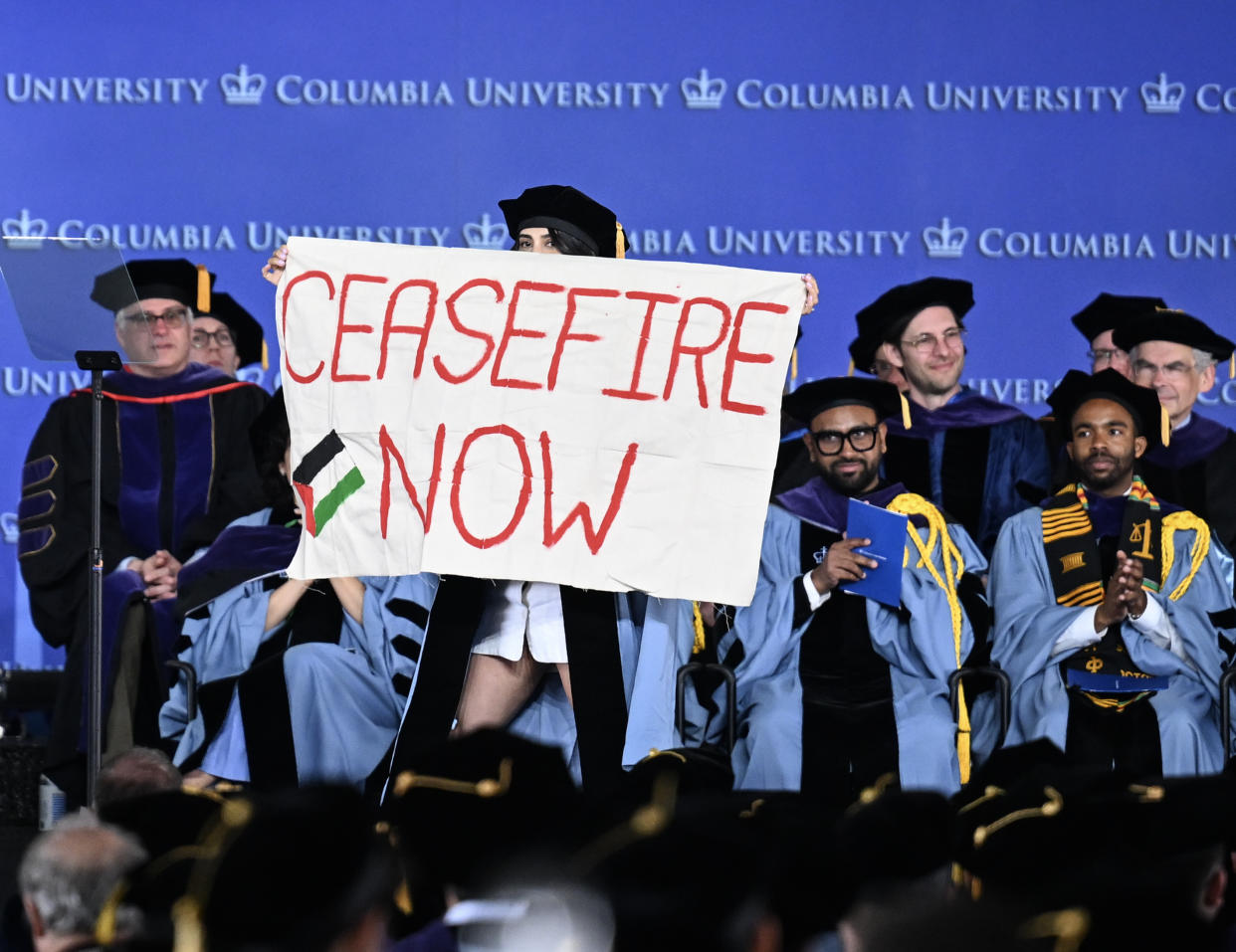 Columbia law school graduates carry out a silent pro-Palestinian protest with a banner reading 