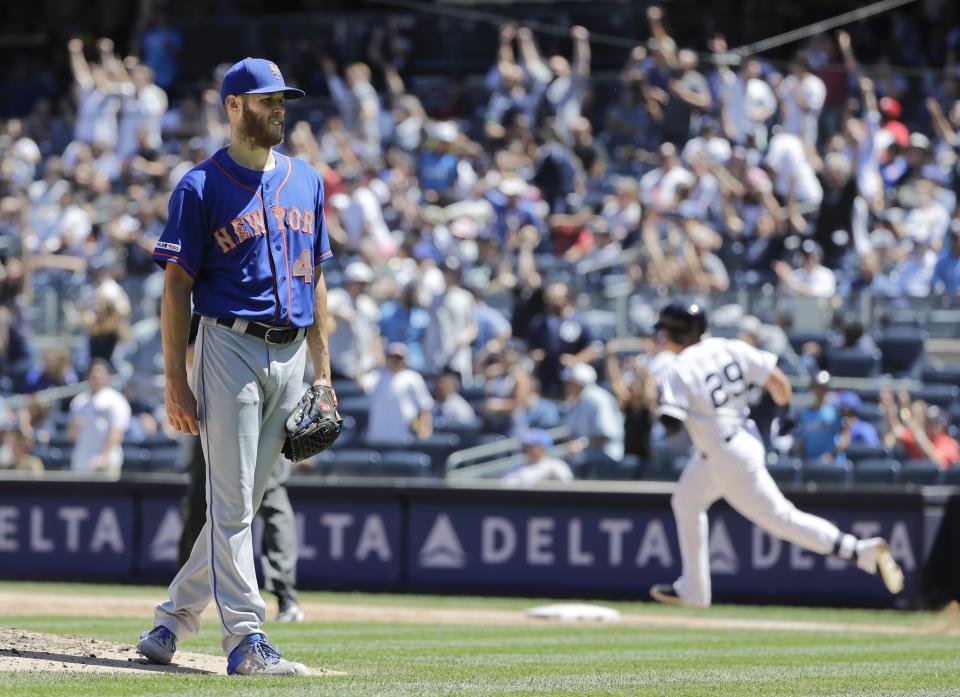 New York Mets starting pitcher Zack Wheeler, left, reacts as New York Yankees' Gio Urshela runs the bases after hitting a two-run home run during the fourth inning in the first baseball game of a doubleheader, Tuesday, June 11, 2019, in New York. (AP Photo/Frank Franklin II)