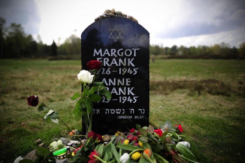 Flowers and stones lay on and in front of the gravestone of Margot Frank and Anne Frank (Getty Images)