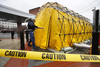 Steve Moody, director of nursing at Central Maine Medical Center, enters a tent outside the emergency entrance to the hospital to test patients who have symptoms of the coronavirus, Friday, March 13, 2020, in Lewiston, Maine. U.S. hospitals are setting up circus-like triage tents, calling doctors out of retirement, guarding their supplies of face masks and making plans to cancel elective surgery as they brace for an expected onslaught of coronavirus patients. (AP Photo/Robert F. Bukaty)