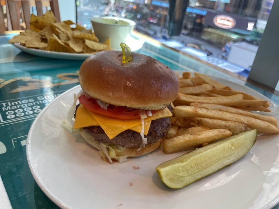 Cheeseburger with fries and pickle at Margaritaville