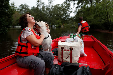 Susan Hedgpeth hugs her dog Cooper, as they go to higher ground via the United States Coast Guard during Tropical Storm Florence in Lumberton, North Carolina, U.S. September 16, 2018. REUTERS/Randall Hill