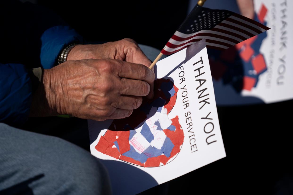 Nov 10, 2023; Dublin, Ohio, USA; Vietnam veteran, Tom Ottman, 78, of Hilliard, holds a flag during the annual Veterans Day Ceremony at the Grounds of Remembrance in Dublin Veterans Park.