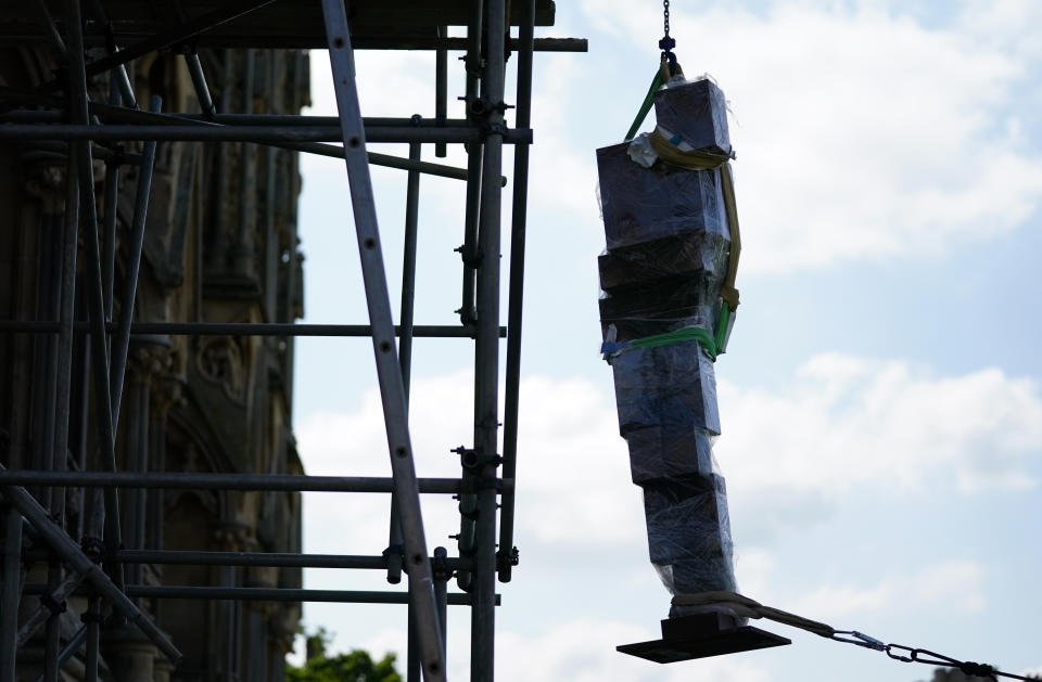 <p>Antony Gormley's sculpture 'Doubt' is lifted onto scaffolding before being installed on the West Front of Wells Cathedral, Wells, Somerset. Picture date: Thursday August 26, 2021.</p>
