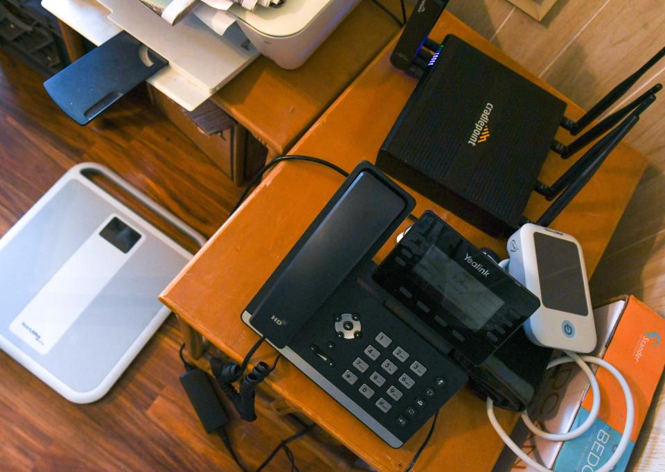 A scale, a modem, a telephone and a blood pressure cuff, pictured Friday, Sept. 15, 2023, at Patricia and Michael Yasky's Fort Pierce, Fla., home, helped connect the mother and son to caregivers at Cleveland Clinic Indian River Hospital in Vero Beach. Patricia, 92, who has Type 1 diabetes and congestive heart failure, was an inpatient in the hospital's new Care At Home program. “If I was a billionaire, I couldn’t have gotten better treatment,” she said.