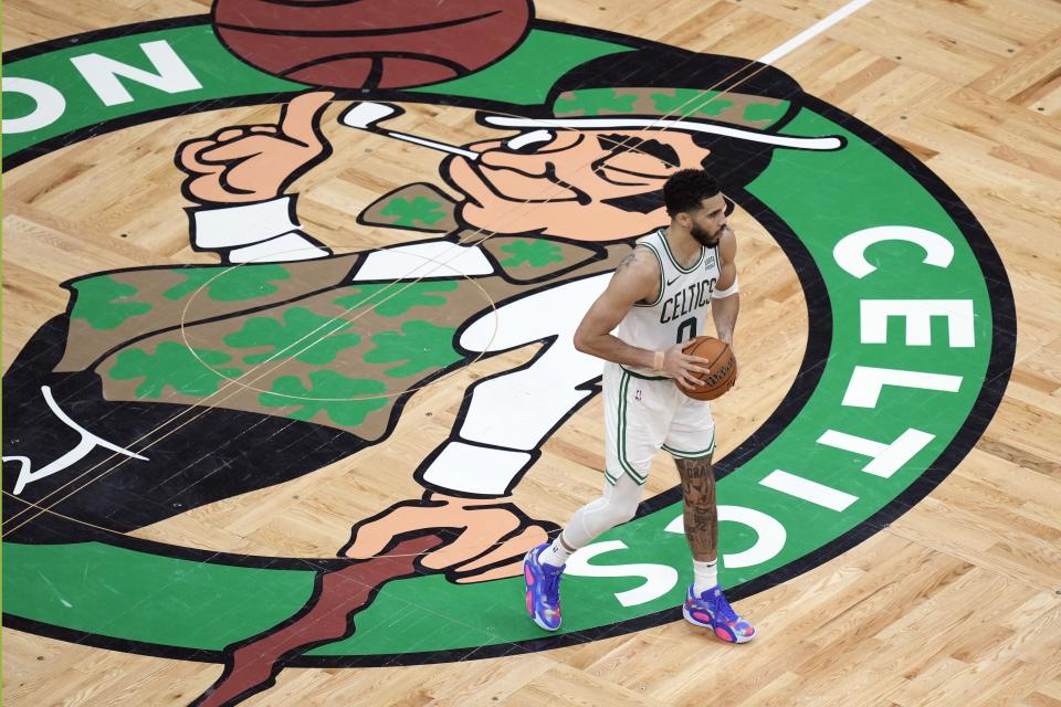 Boston Celtics' Jayson Tatum (0) holds the ball near midcourt during the second half of Game 1 of the basketball team's NBA Finals against the Dallas Mavericks on Thursday, June 6, 2024, in Boston.(AP Photo/Michael Dwyer)