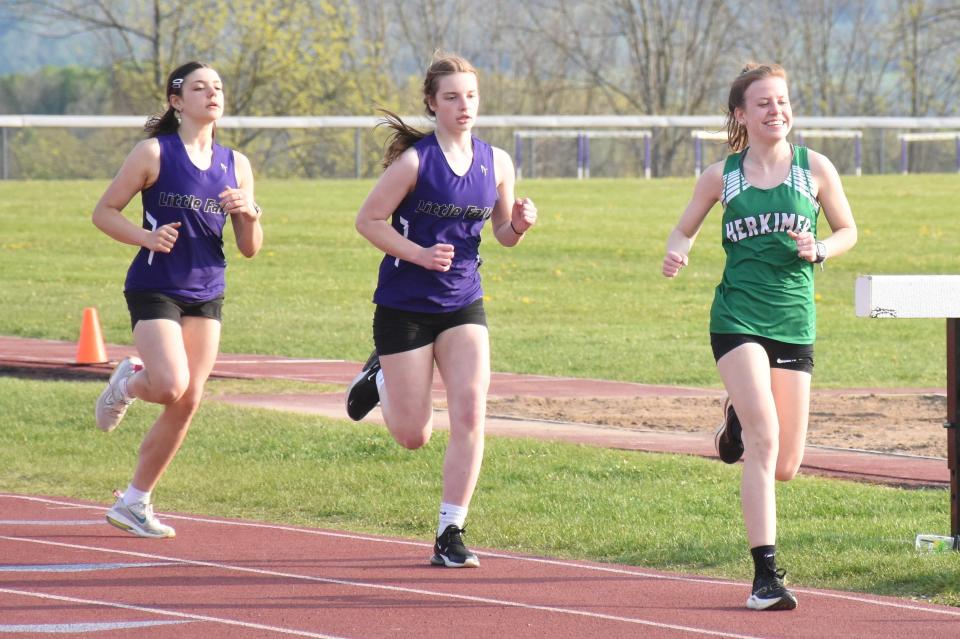 Herkimer Magician Abigail Polus (right) leads the 3,000-meter race in Little Falls Wednesday.