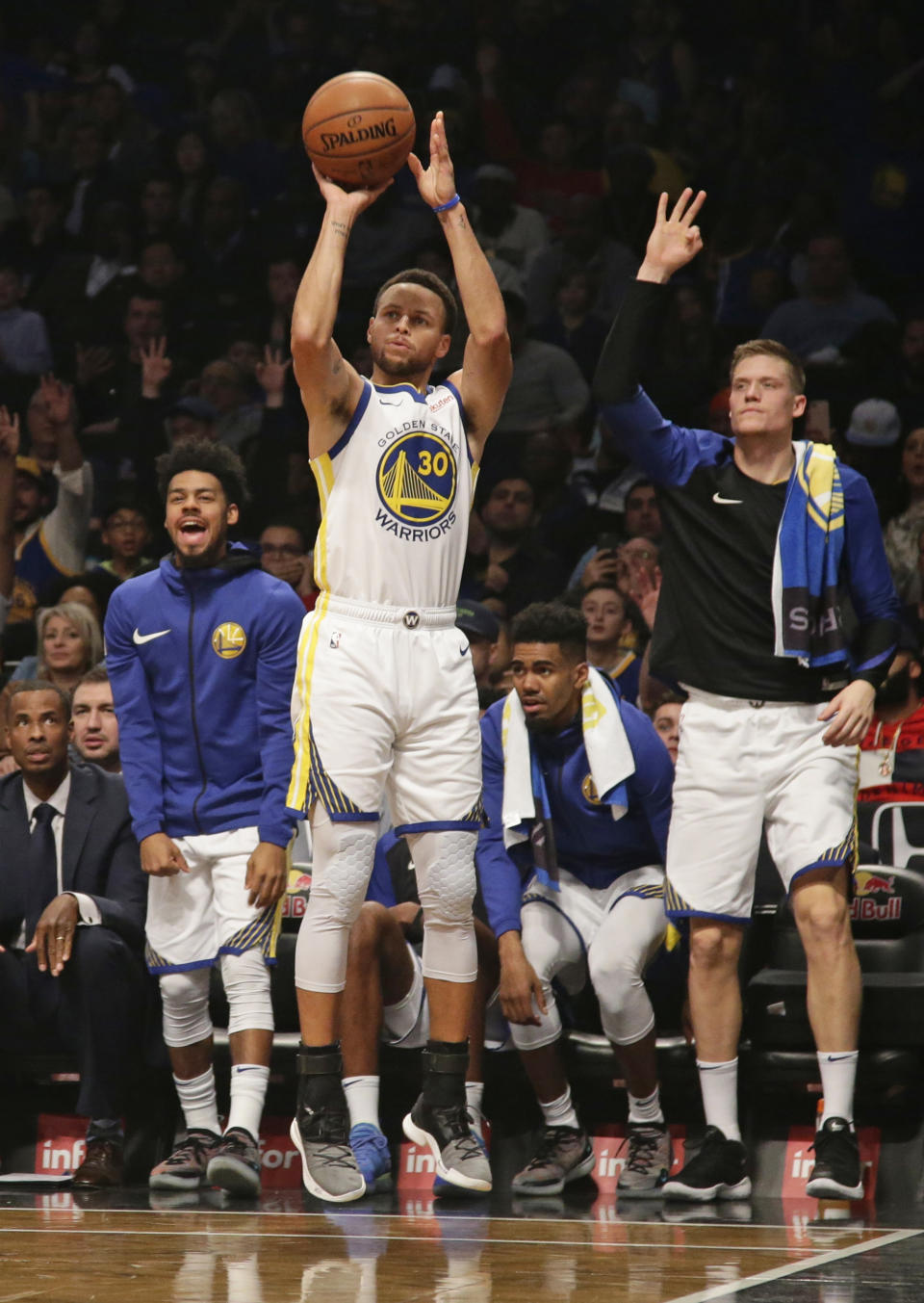 Golden State Warriors react as teammate Stephen Curry shoots a three-point basket during the first half of an NBA basketball game against the Brooklyn Nets, Sunday, Oct. 28, 2018, in New York. (AP Photo/Frank Franklin II)