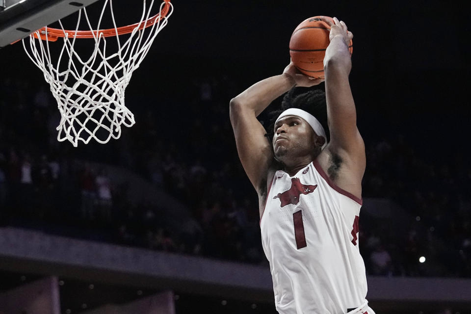 Arkansas guard Ricky Council IV (1) goes up for a dunk in the second half of an NCAA college basketball game against Oklahoma, Saturday, Dec. 10, 2022, in Tulsa, Okla. (AP Photo/Sue Ogrocki)