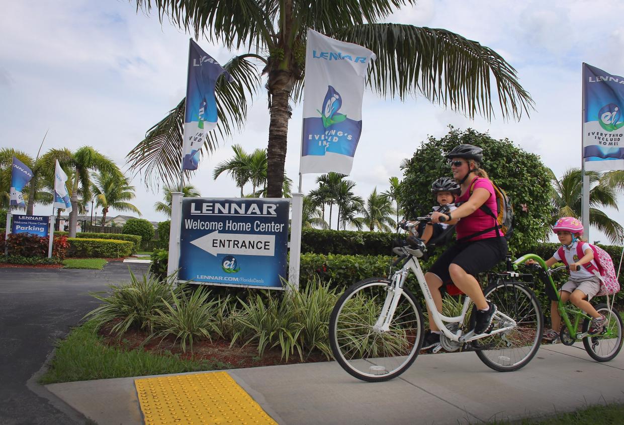 MIAMI, FL - SEPTEMBER 25: A family rides their bike past a Lennar Corp sign, as the company reports that it's third-quarter net income ending on August 31st rose to $87.1 million, or 40 cents a share, from $20.7 million, or 11 cents, a year earlier on September 25, 2012 in Miami, Florida. The company said the better than expected quarter was due to demand for new houses has climbed and a real estate recovery is gaining traction.  (Photo by Joe Raedle/Getty Images)
