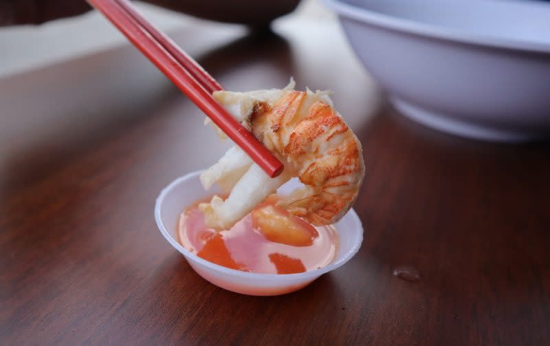 jia li seafood soup - closeup of crayfish dipped in chilli