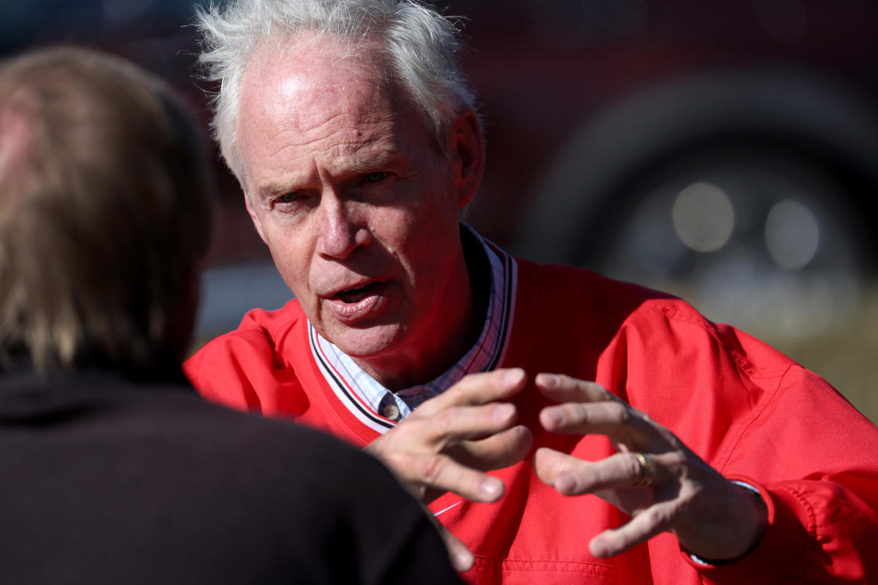 Sen. Ron Johnson speaks to a reporter during a campaign stop in Muskego, Wis. 