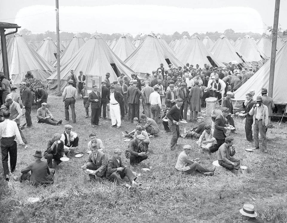 Members of the Bonus Army are shown eating their lunches beside their tents in this May 12, 1932, photograph. <a href="https://www.gettyimages.com/detail/news-photo/members-of-the-bonus-expeditionary-force-also-called-bonus-news-photo/514685392?phrase=bonus%20army&adppopup=true" rel="nofollow noopener" target="_blank" data-ylk="slk:Bettmann/GettyImages;elm:context_link;itc:0;sec:content-canvas" class="link ">Bettmann/GettyImages</a>