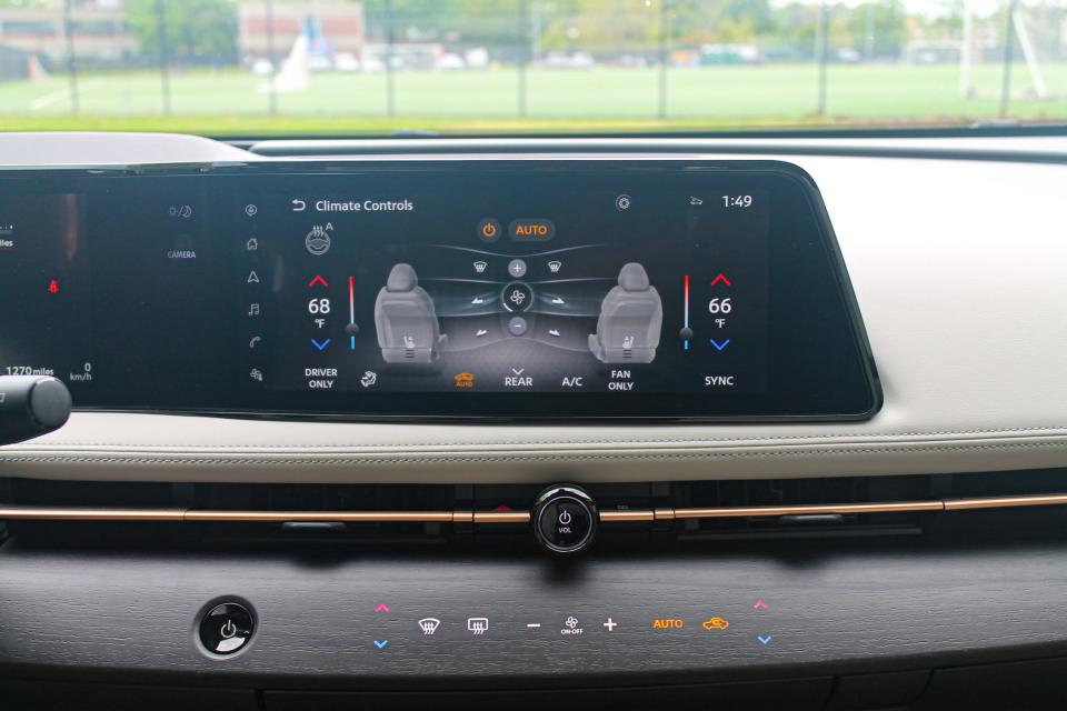 The 2023 Nissan Ariya's infotainment screen displays climate functions.
