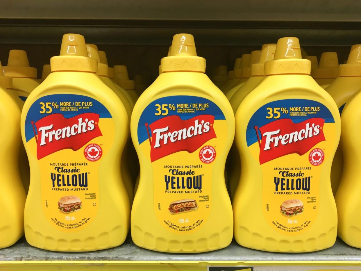 Yellow plastic squeeze bottles of French's mustard sauce