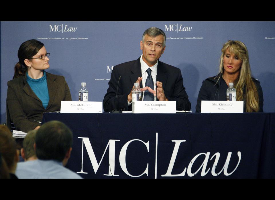 Amelia McGowan, an attorney for the ACLU of Mississippi, left, and Rebecca Kiessling, a family law attorney, right, listen as Stephen Crampton, general counsel for Liberty Counsel discusses the implications of Mississippi's Personhood Initiative in a symposium Tuesday night, Oct. 25, 2011 at the Mississippi College School of Law in Jackson, Miss. The practicing attorneys, law professors and others debated the implications of the state ballot initiative that would declare life begins when a human egg is fertilized. (AP Photo/Rogelio V. Solis)