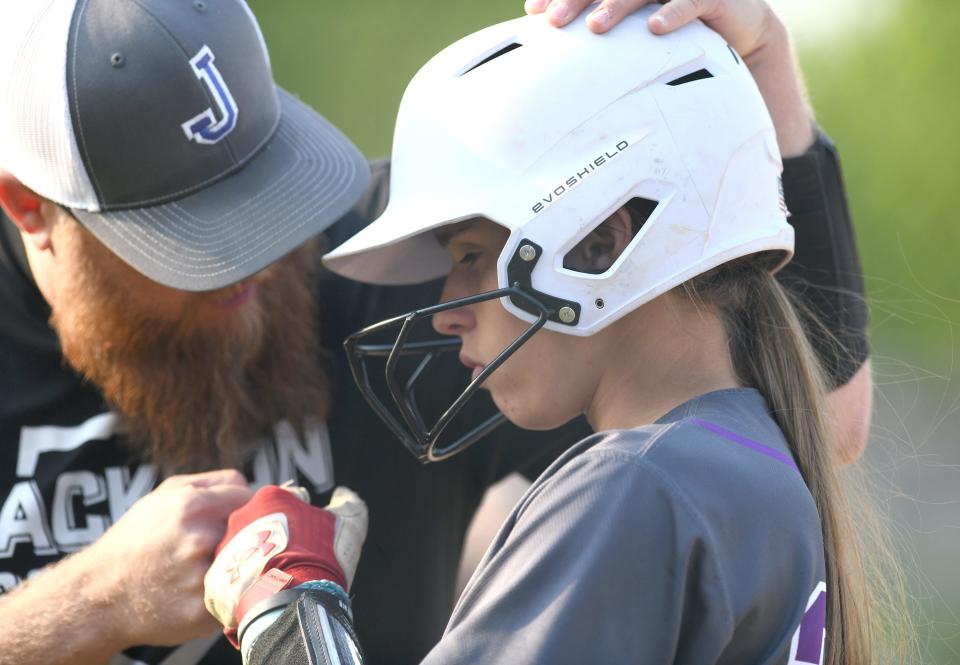 Jackson softball coach Adam Parker talks to Morgan Christopher before a fifth-inning at-bat against Hoover in the Division I district final in Massillon, Wednesday, May 17, 2023.