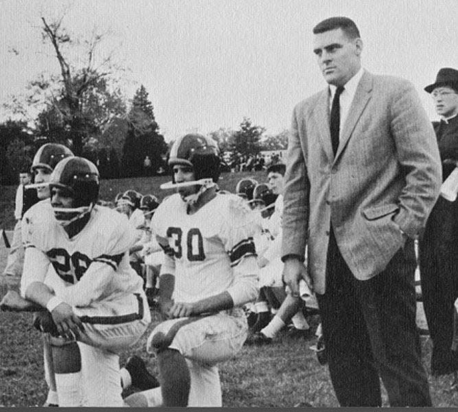 Joe Biden (30) crouches beside Archmere coach John Walsh (second from right) in 1960.