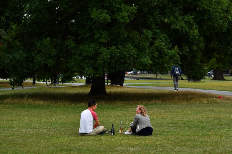 Friends enjoy a picnic on Clapham Common in London