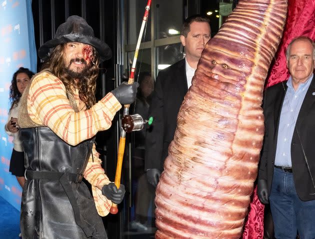 Heidi Klum and husband Tom Kaulitz dressed up as a worm and a fisherman, respectively. (Photo: Gilbert Carrasquillo via Getty Images)