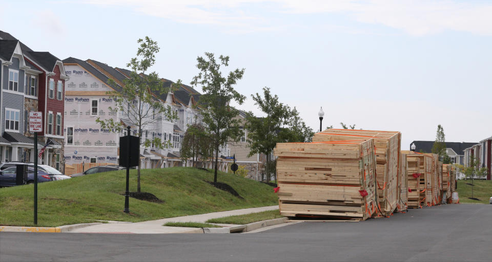 In this photo taken Sept. 18, 2016, pallets of pre-fabricated sections of new townhouses await assembly in the South Riding section of Aldie in Loudoun County, Va. New housing construction has soared in the Washington suburbs in recent years. Some completed units and others partially done are shown.(AP Photo/Harry Hamburg)