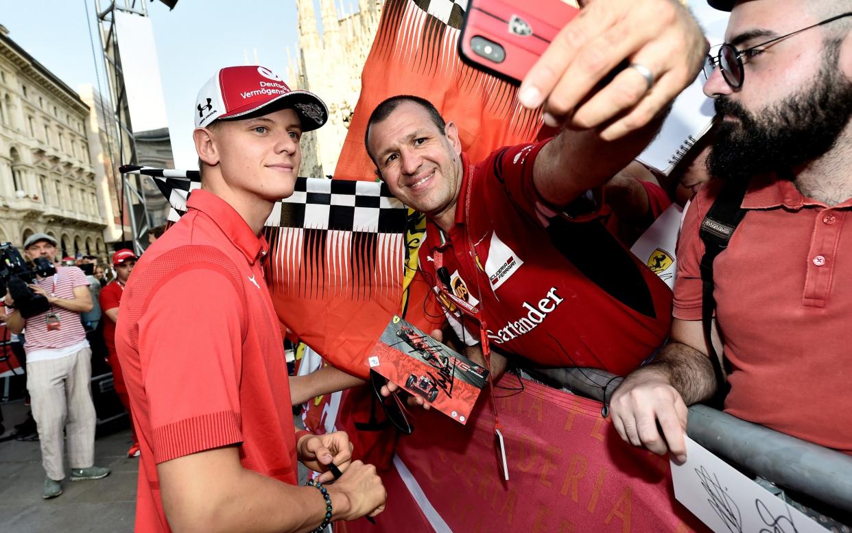 Mick Schuamcher (left) shakes hands with a F1 fan - REUTERS