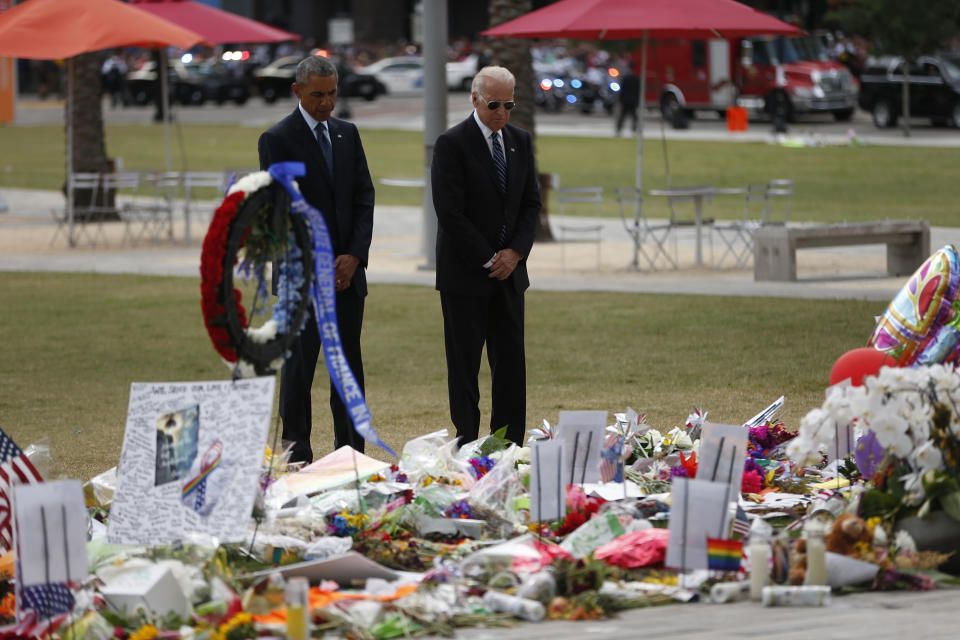 <p>The president and vice president pause after placing flowers at a memorial in Orlando, Fla., June 16, 2016. (AP/Pablo Martinez Monsivais) </p>