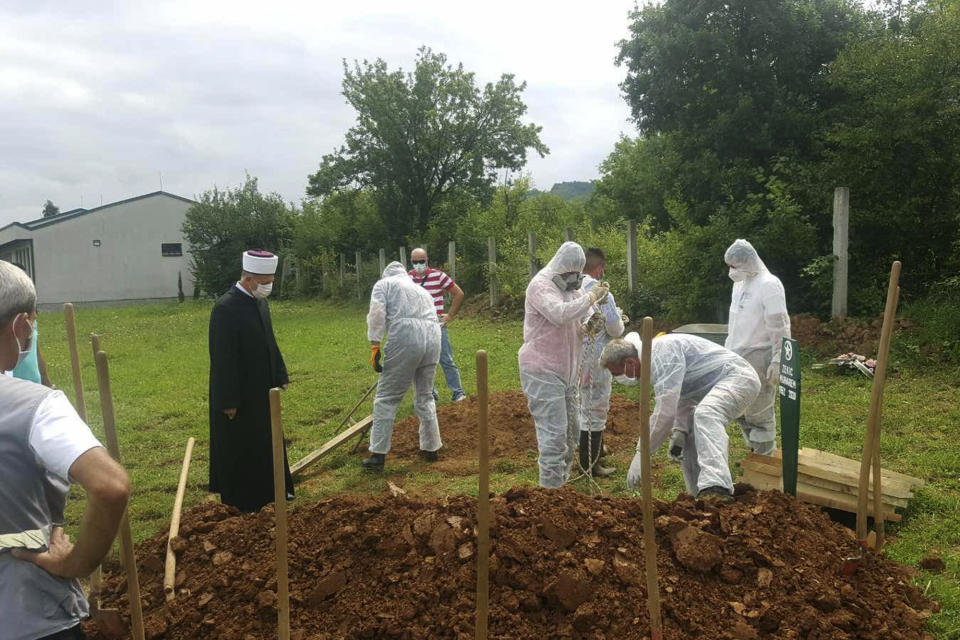 The funeral of Muharem Zekic who died of Covid related complications is held in Zenica, Bosnia, Monday, Aug. 24, 2020. The coronavirus skeptics and rebels in Bosnia grow louder in step with the rising number of infections in the country. Recently, several families who lost their loved ones to COVID-19 were confronted online, and some even in real life, by scores of random virus believers and deniers sifting through their pain and questioning their relatives’ cause of death. (AP Photo/Tarik Svraka)