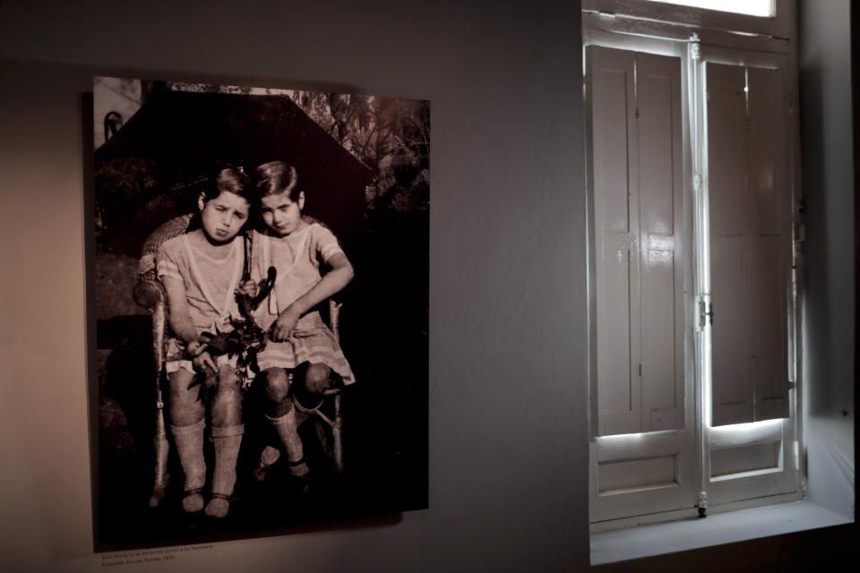 A 1926 photograph of Eva Perón, right, with her sister Erminda hangs in the home she was born and raised in until her 11th birthday, in Los Toldos, Argentina, Monday, May 6, 2019. One day ahead of the 100th anniversary of Evita's birth, the home where Argentina's mythical first lady was born and raised was opened to the public with an exhibition recounting the childhood of the woman who, together with her husband Juan Domingo Perón, will forever mark Argentine history. (AP Photo/Natacha Pisarenko)