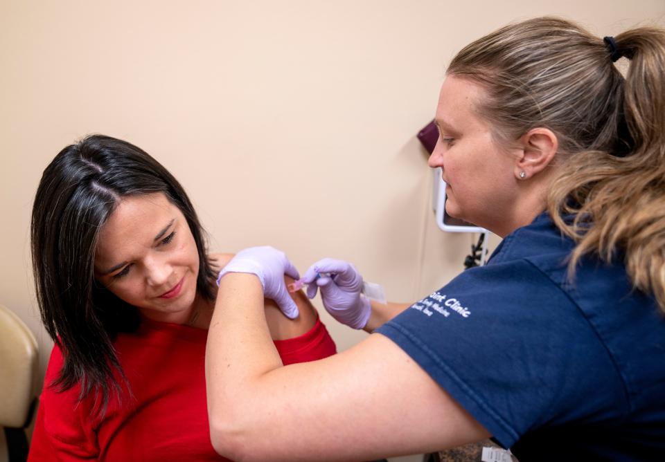 Libby Moench gets a flu shot from CMA Emily Howard at the UnityPoint Clinic in Norwalk, Friday, Sept. 15, 2023.