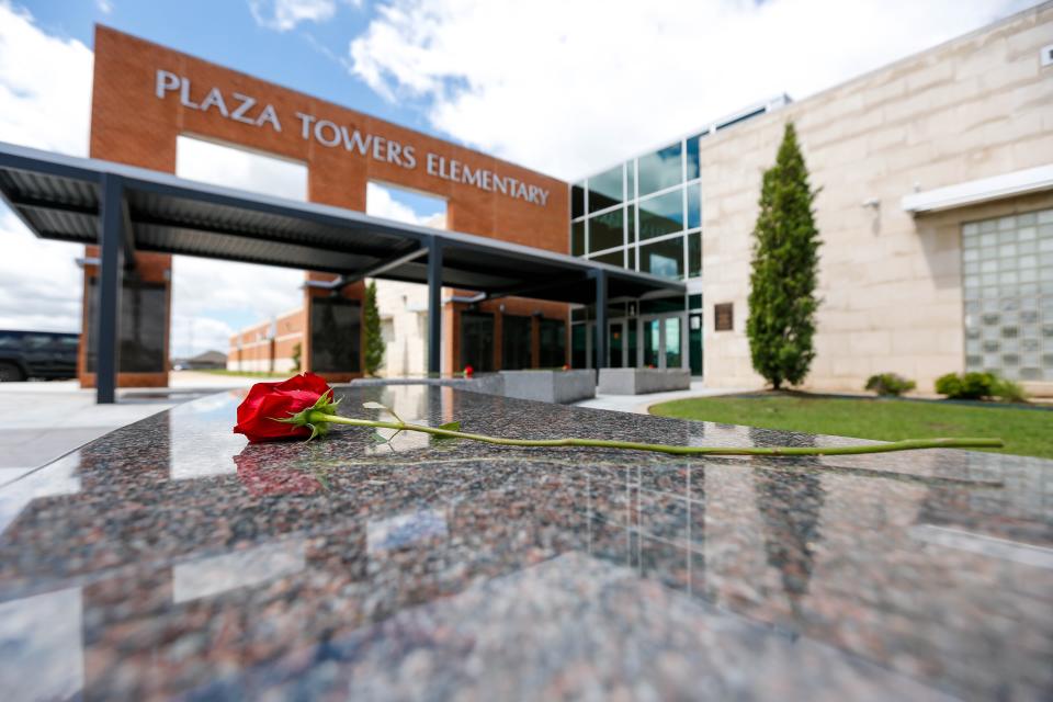 Roses sit Friday on a memorial at Plaza Towers Elementary in Moore.