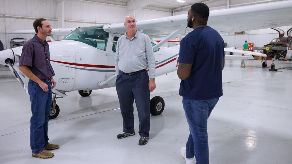Students Branson Cruse, left, and Brandon Nelson, right, prepare for a lesson at River Falls Airport with Dr. Paul Clark, a WT history professor who teaches flight lessons in his spare time.