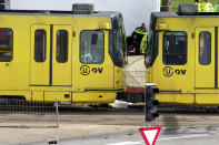 A body is covered with a white sheet after a shooting in a tram in Utrecht, Netherlands, Monday, March 18, 2019. Police in the central Dutch city of Utrecht say on Twitter that "multiple" people have been injured as a result of a shooting in a tram in a residential neighborhood. (AP Photo/Peter Dejong)