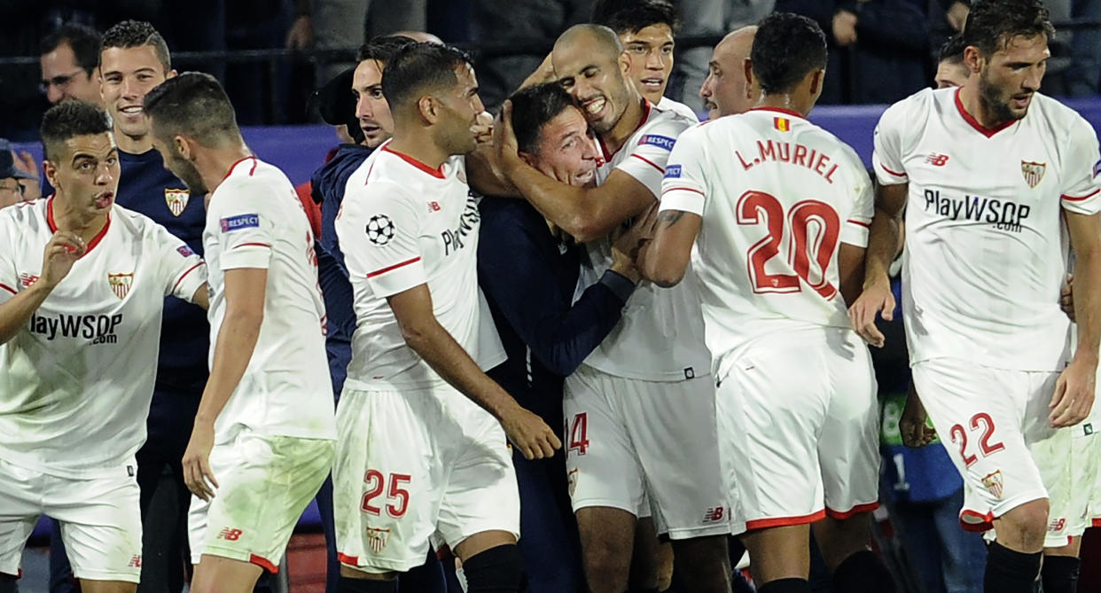 Sevilla’s Argentinian midfielder Guido Pizarro celebrates with Sevilla’s Argentinian coach Eduardo Berizzo