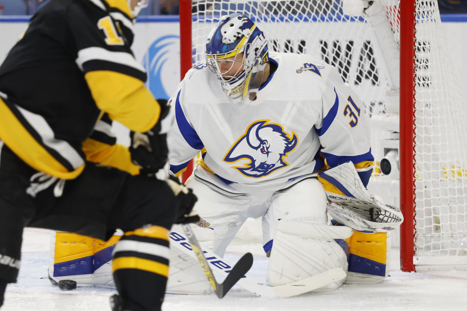 Buffalo Sabres goaltender Eric Comrie (31) makes a pad save during the second period of the team's NHL hockey game against the Pittsburgh Penguins, Wednesday, Nov. 2, 2022, in Buffalo, N.Y. (AP Photo/Jeffrey T. Barnes)