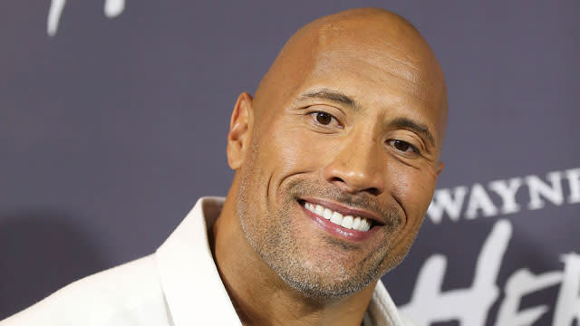 Dwayne 'The Rock' Johnson helps a 2-year-old pull a plane: see the video