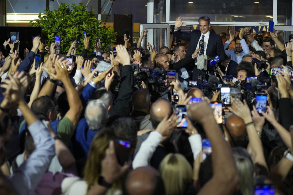 Greece's Prime Minister and leader of New Democracy Kyriakos Mitsotakis, top, addresses supporters at the headquarters of his party in Athens, Greece, Sunday, May 21, 2023. The conservative party of Greek Prime Minister Kyriakos Mitsotakis has won a landslide election but without enough parliamentary seats to form a government. (AP Photo/Petros Giannakouris)