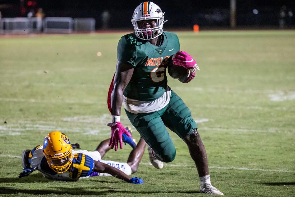 Dolphin junior Randy Pittman powers his way into the end zone for his third touchdown of the game. Mosley hosted Rickards at Tommy Oliver Stadium Friday, October 15, 2021. The Dolphins came away winners 28-13 to keep their perfect season alive.