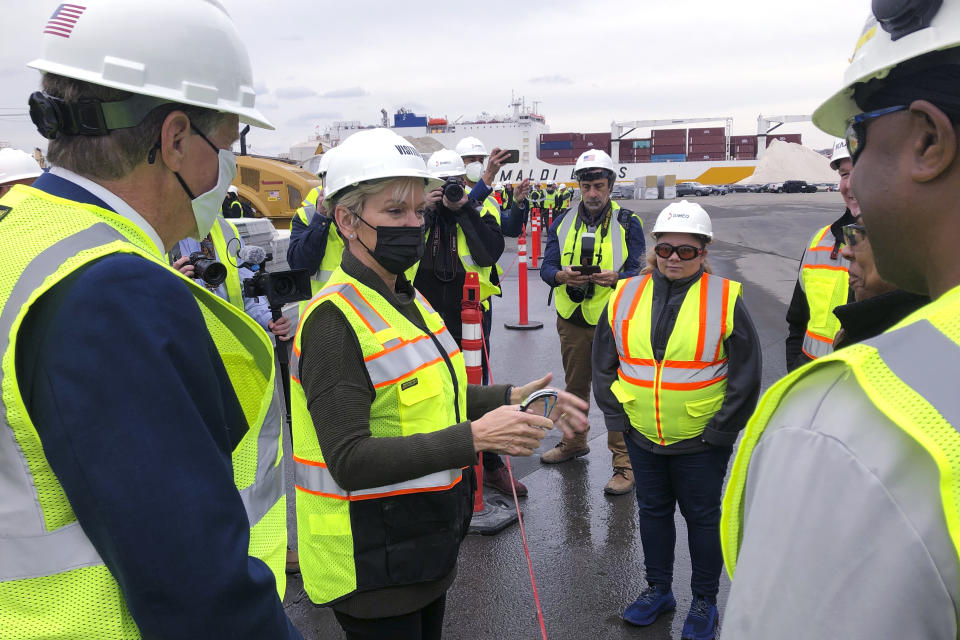 U.S. Energy Secretary Jennifer Granholm, center, speaks with workers, and Rhode Island Gov. Dan McKee, left, Thursday Dec. 2, 2021, while visiting an under construction fabrication and assembly facility for offshore wind turbines at the Port of Providence, in Providence, R.I. The building is scheduled to be finished this spring to support two offshore wind projects, Revolution Wind and South Fork Wind. (AP Photo/Jennifer McDermott)